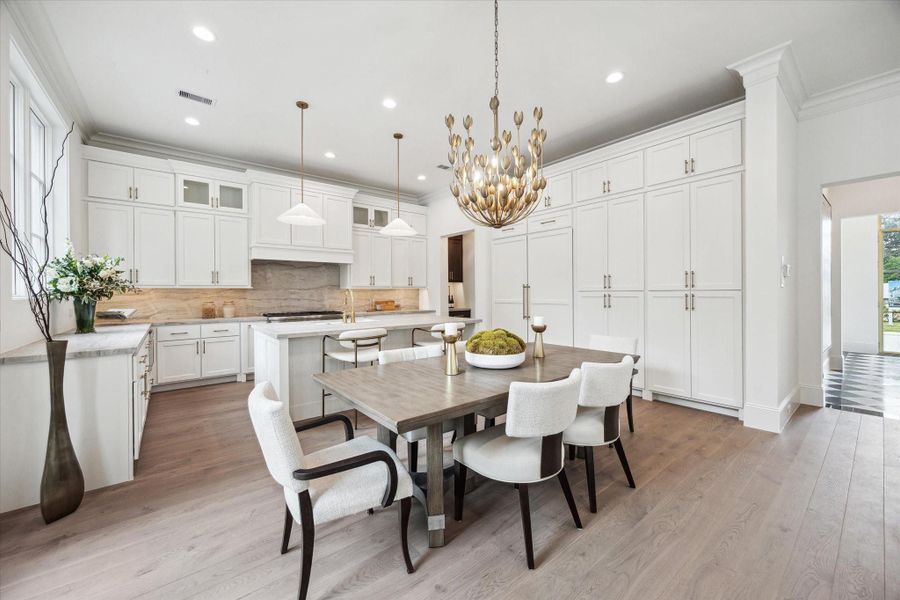 The stunning first floor was designed with relaxation and entertaining in mind! Spacious enough for ample seating, a large dining table, and an island with additional seating that overlooks the living space. *Photo is of another home in the community and for informational purposes only. The stunning first floor was designed with relaxation and entertaining in mind! Spacious enough for ample seating, a large dining table, and an island with additional seating that overlooks the living space. *Photo is of another home in the community and for informational purposes only.