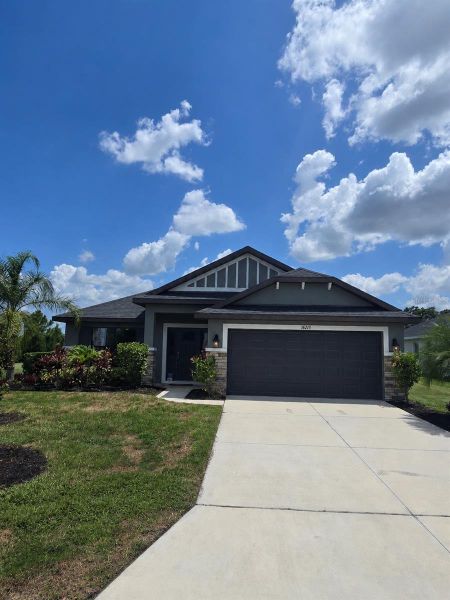 Front exterior of a new home in Aviary at Rutland Ranch, Parrish, FL, highlighting curb appeal (Image 1). Front exterior of a new home in Aviary at Rutland Ranch, Parrish, FL, highlighting curb appeal (Image 1).