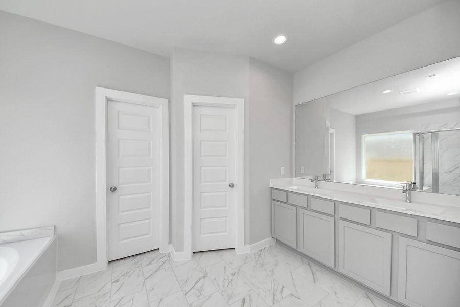 Elevate your daily routine at the elegant vanity, now equipped with double sinks, light countertops, modern hardware, and beautiful recessed lights. Elevate your daily routine at the elegant vanity, now equipped with double sinks, light countertops, modern hardware, and beautiful recessed lights.