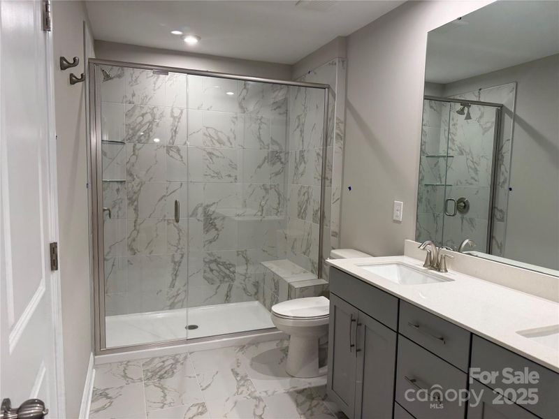 Actual 2nd Primary Bath with Gray cabinets, white quartz and Marble Style tile. Actual 2nd Primary Bath with Gray cabinets, white quartz and Marble Style tile.