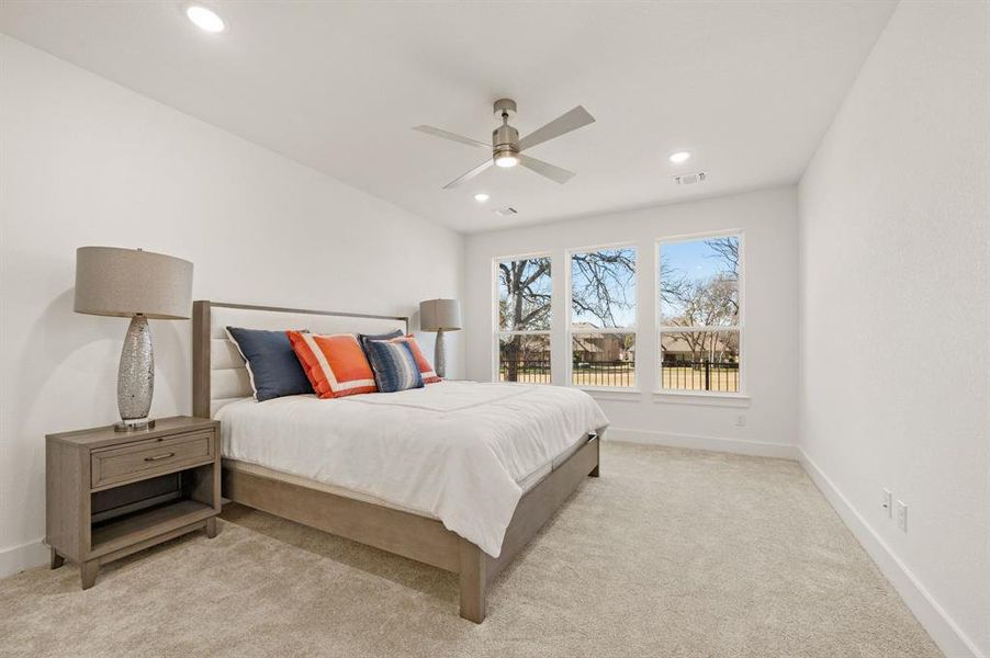 Bedroom featuring ceiling fan, light colored carpet, and recessed lighting