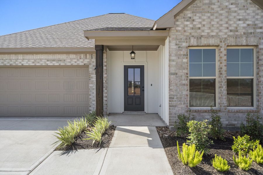Front exterior of a new home in Emberly 55, Beasley, TX, highlighting curb appeal (Image 18). Front exterior of a new home in Emberly 55, Beasley, TX, highlighting curb appeal (Image 18).