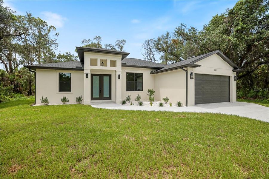 Front exterior of a new home in , Port Charlotte, FL, highlighting curb appeal (Image 16).