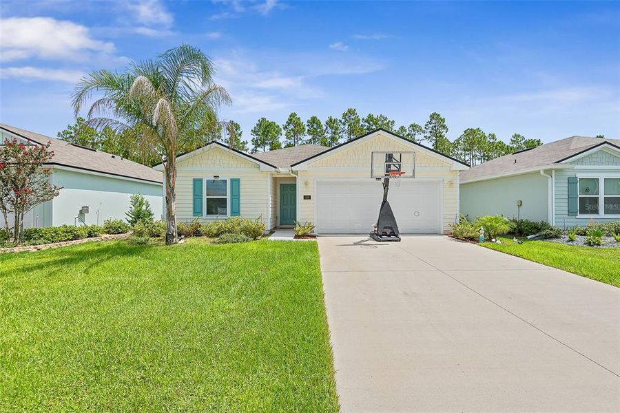 Front exterior of a new home in Sawmill Branch, Palm Coast, FL, highlighting curb appeal (Image 23).