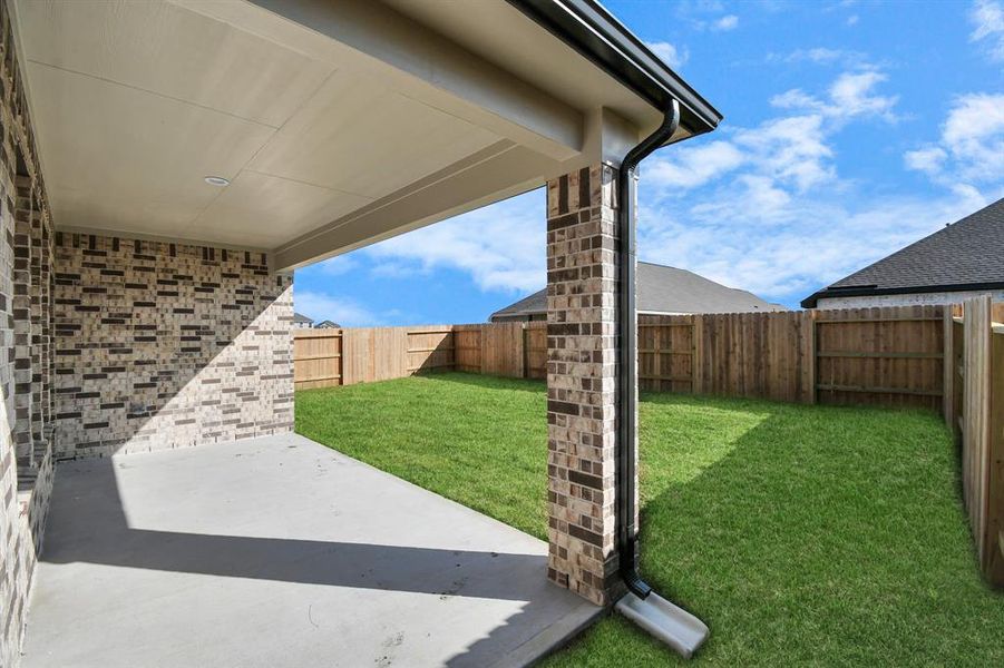 Experience outdoor living at its finest on this expansive covered patio, thoughtfully designed for BBQs and delightful outdoor dining.