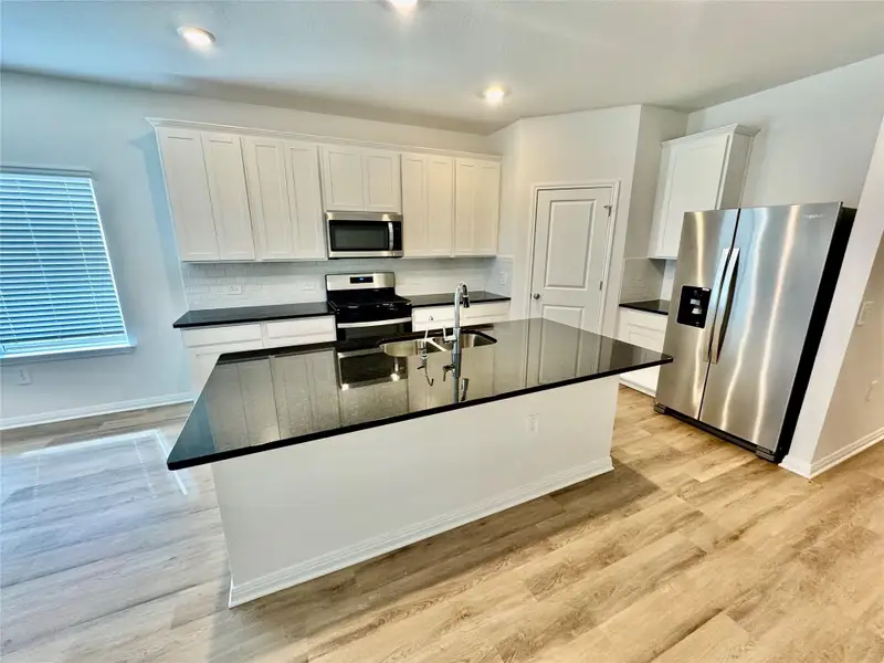Furnished interior view inside a new home in Lexington Parke, Del Valle (Image 4).