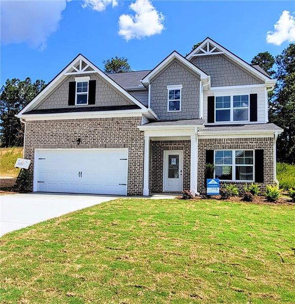 Front exterior of a new home in The Hills at Cedar Creek, Winder, GA, highlighting curb appeal (Image 2). Front exterior of a new home in The Hills at Cedar Creek, Winder, GA, highlighting curb appeal (Image 2).