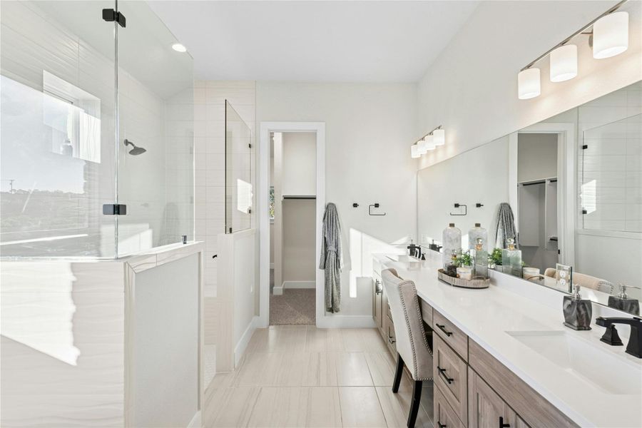 Full bath with a spacious closet, double vanity, tiled shower, and recessed lighting Full bath with a spacious closet, double vanity, tiled shower, and recessed lighting
