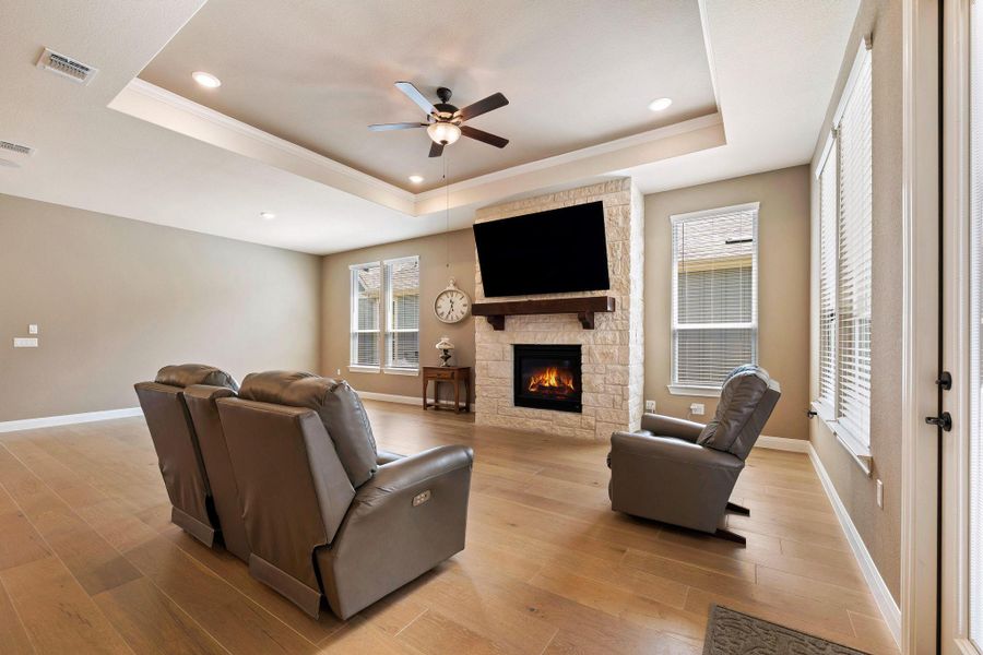 A comforting living room offers a stone-clad fireplace and light wood flooring. A comforting living room offers a stone-clad fireplace and light wood flooring.