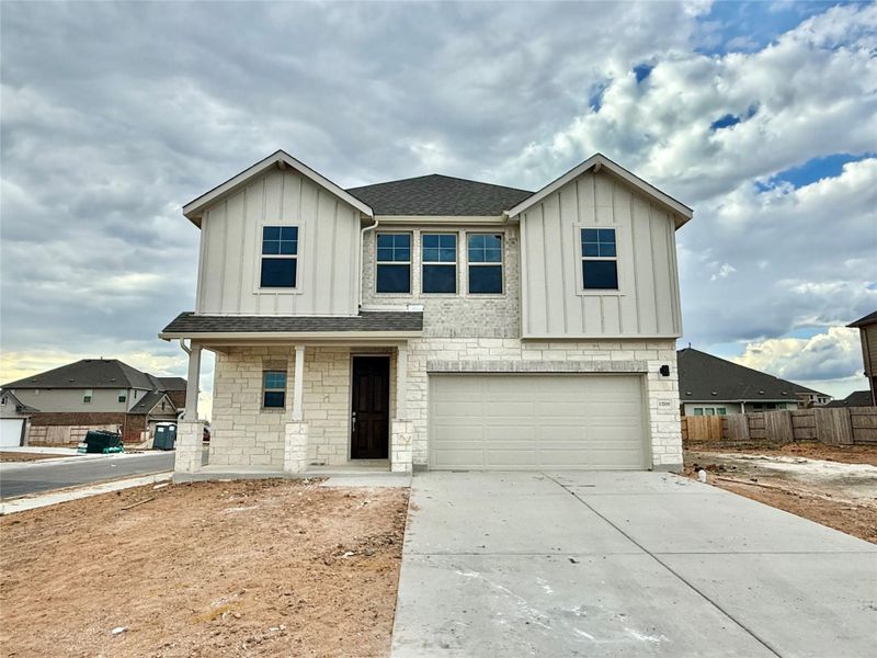 View of front of property featuring board and batten siding, stone siding, and roof with shingles View of front of property featuring board and batten siding, stone siding, and roof with shingles