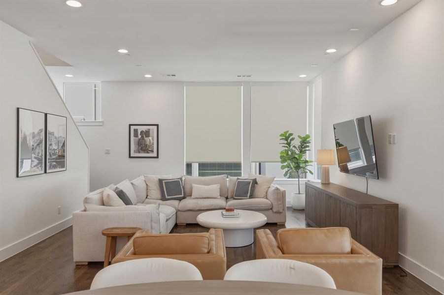 Living room featuring dark wood-style floors and recessed lighting