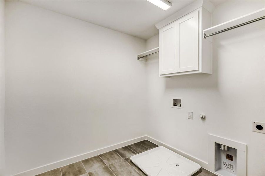 Laundry room with hookup for a gas dryer, washer hookup, cabinet space, and hookup for an electric dryer