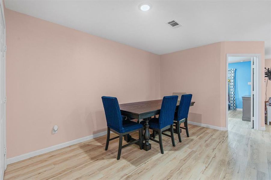 Dining space with light wood finished floors and baseboards Dining space with light wood finished floors and baseboards