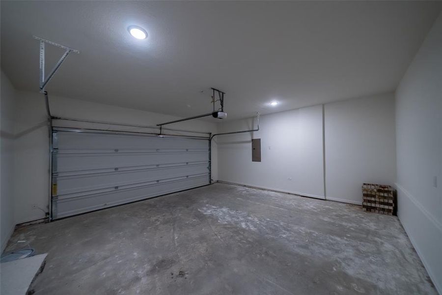 Garage with a garage door opener and electric panel