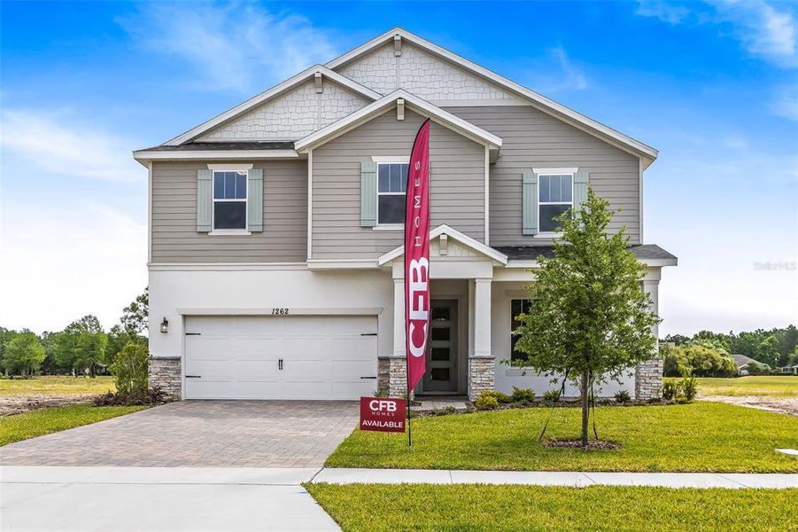 Front exterior of a new home in Gray Hawk at Hole Two, Daytona Beach, FL, highlighting curb appeal (Image 27). Front exterior of a new home in Gray Hawk at Hole Two, Daytona Beach, FL, highlighting curb appeal (Image 27).