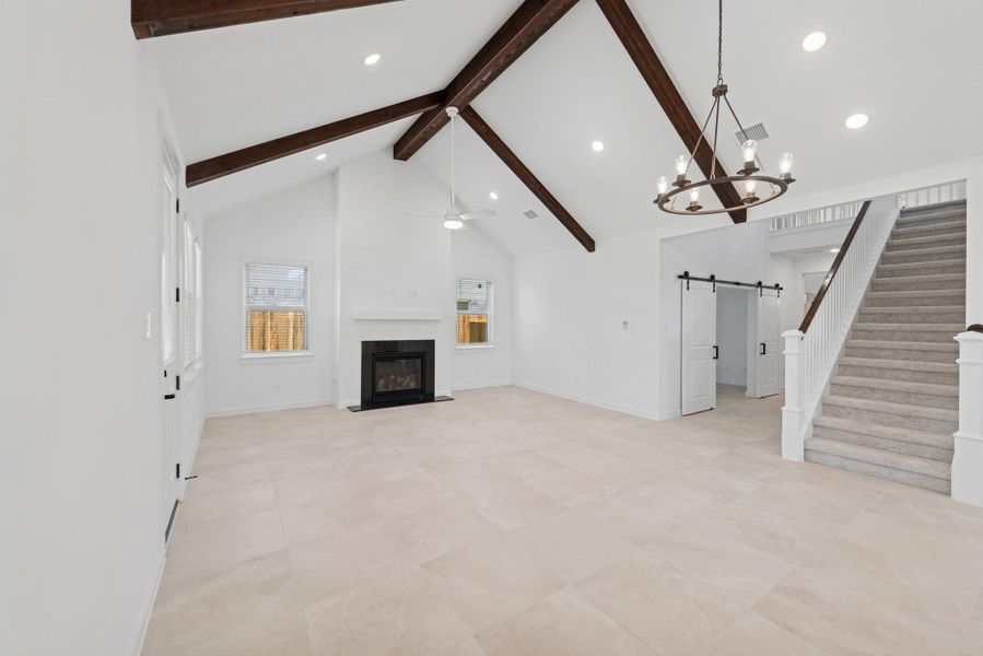 Open great room and dining area with cozy fireplace