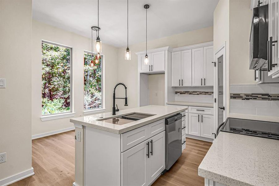 Kitchen with center island. Large sink and dishwasher on the island complete with additional storage!