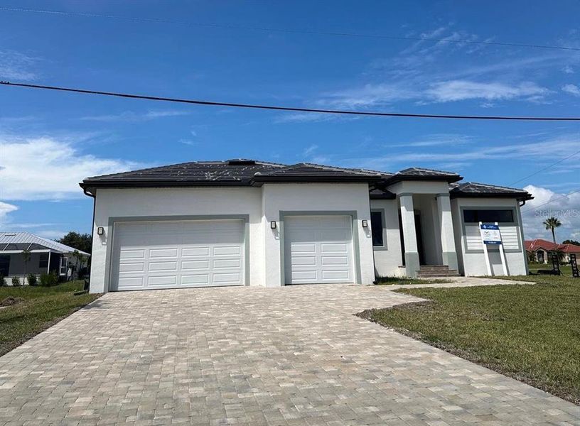 Front exterior of a new home in , Punta Gorda, FL, highlighting curb appeal (Image 1). Front exterior of a new home in , Punta Gorda, FL, highlighting curb appeal (Image 1).