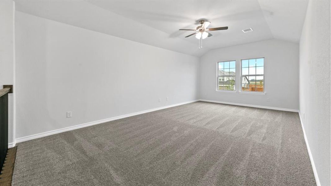 Empty room with dark colored carpet and a ceiling fan Empty room with dark colored carpet and a ceiling fan