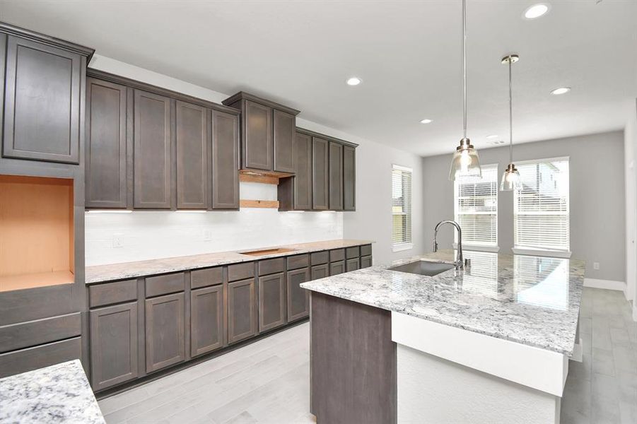 Discover another view of this beautiful kitchen area. Sample photo of completed home with similar floor plan. Actual colors and selections may vary.