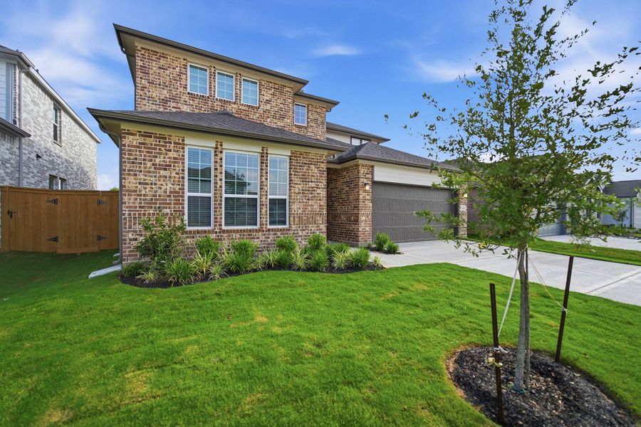 Front exterior of a new home in Sunterra Lakes, Brookshire, TX, highlighting curb appeal (Image 2).