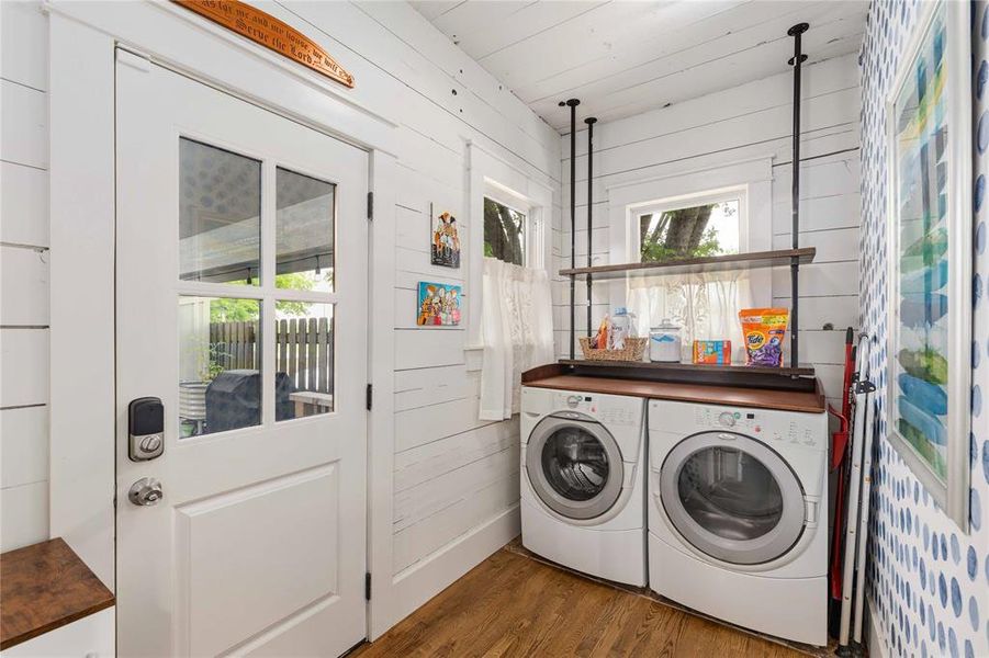 Laundry area featuring shiplap walls, wood-finish flooring, and a glass-paneled exterior door