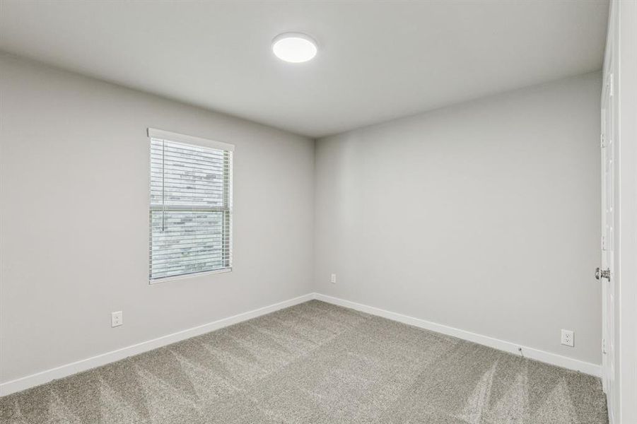 Bedroom in the Harper home plan by Trophy Signature Homes – REPRESENTATIVE PHOTO