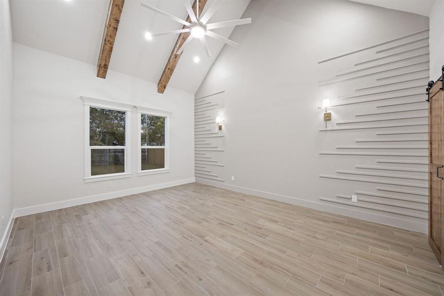 Vaulted ceiling with exposed wood beams and a ceiling fan Vaulted ceiling with exposed wood beams and a ceiling fan