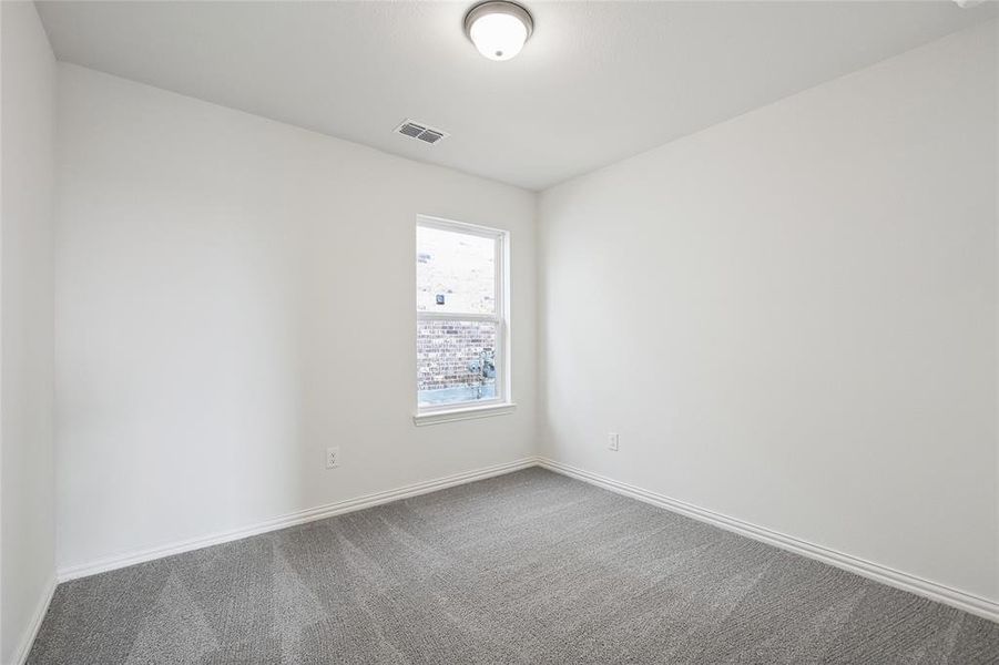 Spare room with baseboards and carpet flooring