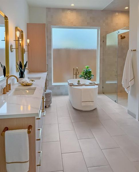 Full bath with a freestanding tub, light tile patterned floors, a stall shower, and double vanity Full bath with a freestanding tub, light tile patterned floors, a stall shower, and double vanity