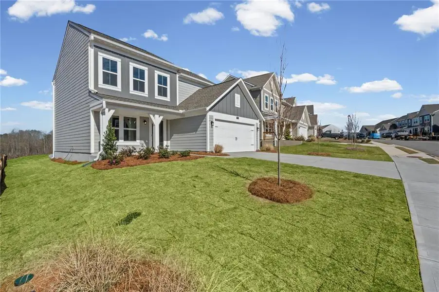 Front exterior of a new home in Twin Lakes, Hoschton, GA, highlighting curb appeal (Image 2). Front exterior of a new home in Twin Lakes, Hoschton, GA, highlighting curb appeal (Image 2).