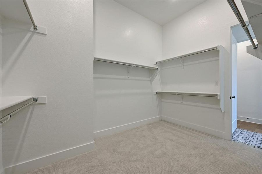 Walk in closet with light colored carpet Walk in closet with light colored carpet