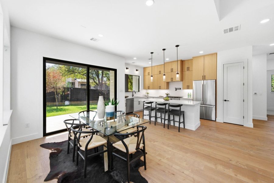 Dining space featuring recessed lighting and light wood-type flooring plus opens to kitchen and access to private backyard Dining space featuring recessed lighting and light wood-type flooring plus opens to kitchen and access to private backyard