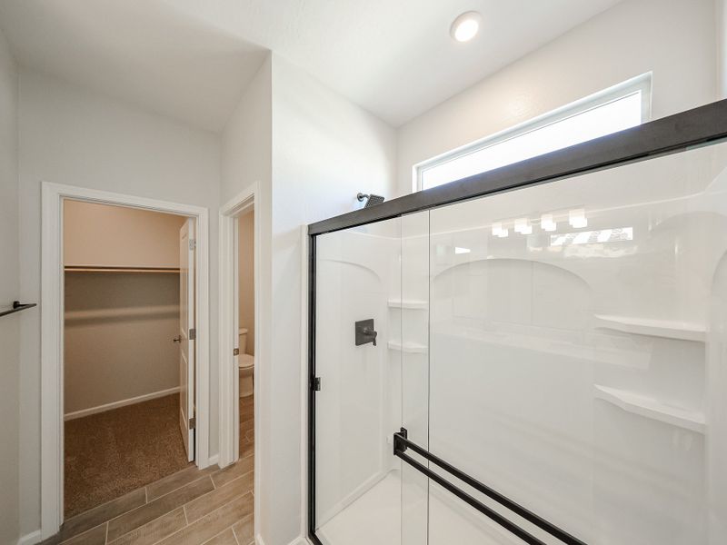 A bathroom with a glass shower. A bathroom with a glass shower.
