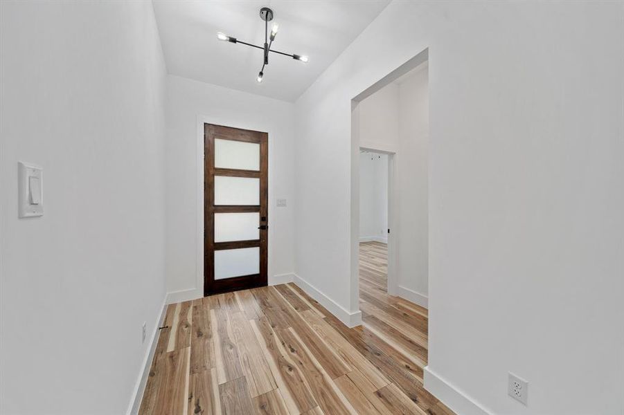 Entryway featuring a chandelier and light wood-type flooring