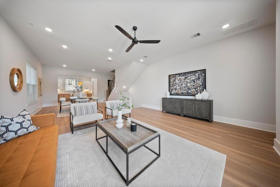 Spacious and inviting living room with modern design, abundant natural light, and seamless flow to the dining area—ideal for relaxing and entertaining.