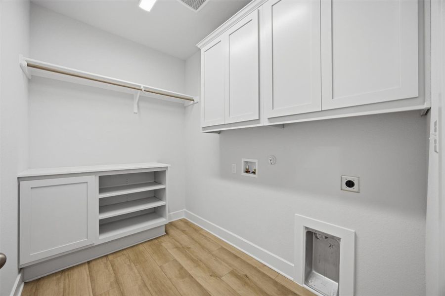 Ample storage and modern flooring define this functional utility space.