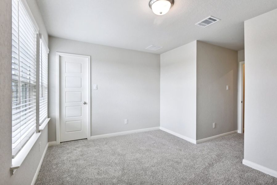 Guest bedroom in the Medina floorplan at a Meritage Homes community.