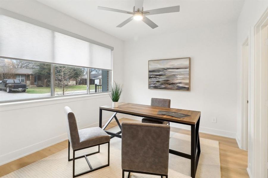 1st floor Office area featuring light wood-style floors, baseboards, and a ceiling fan