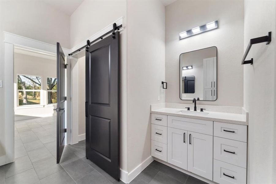 Secondary sink with additional storage and to the left, a walk-in closet.