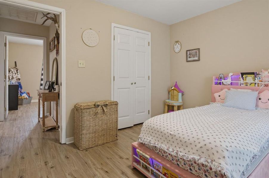 Bedroom featuring wood-finish flooring and neutral wall tones