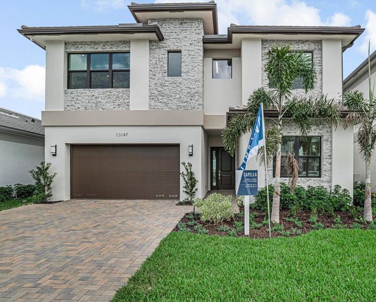 Front exterior of a new home in Apex at Avenir, Palm Beach Gardens, FL, highlighting curb appeal (Image 20).