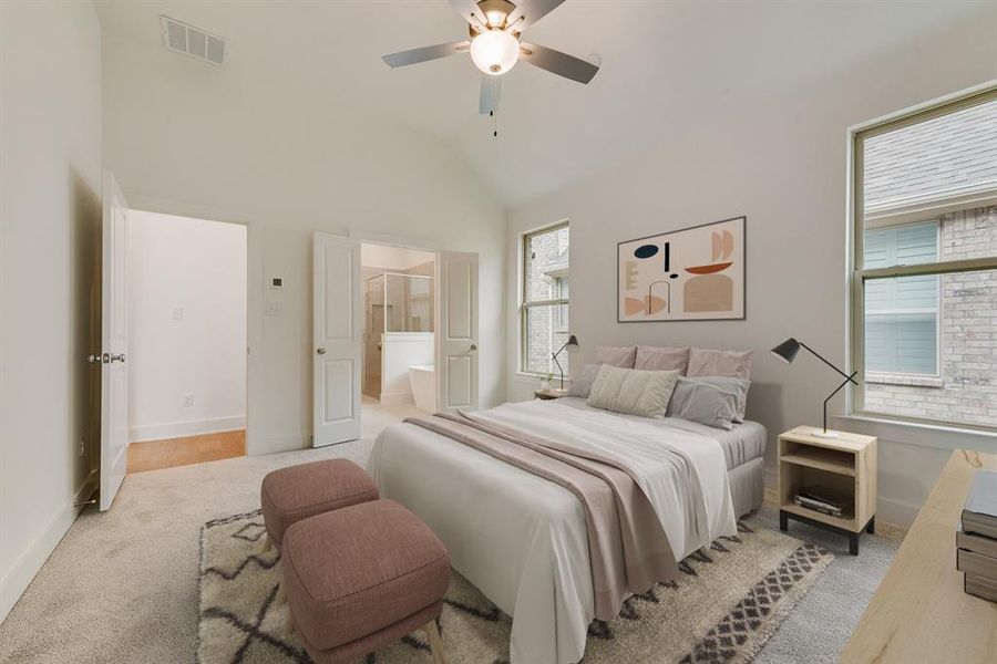 Carpeted bedroom featuring a ceiling fan, ensuite bath, and high vaulted ceiling