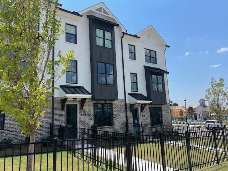 Front exterior of a new home in Palisades Townhomes, Cumming, GA, highlighting curb appeal (Image 25).