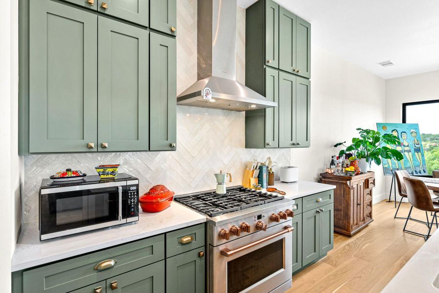 Gleaming stone countertops and custom shaker cabinetry define this modern workspace.
