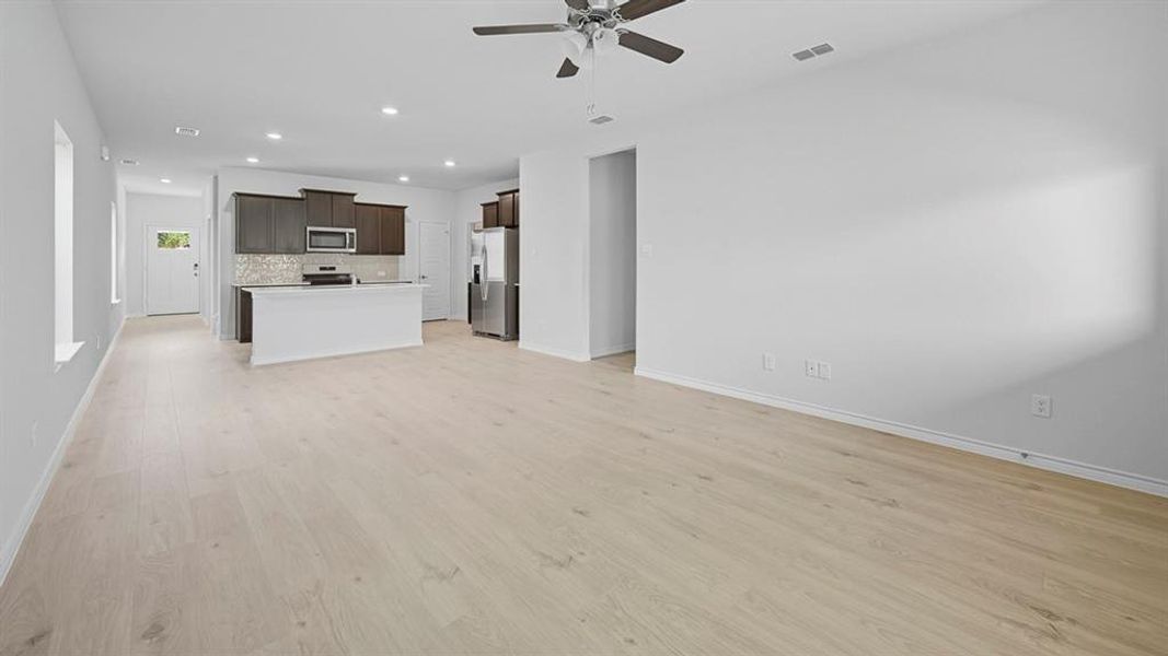 Unfurnished living room with recessed lighting, light wood-type flooring, and a ceiling fan
