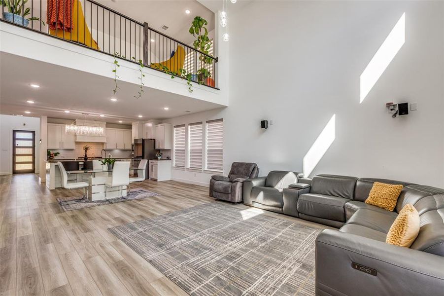 The living room impresses with soaring ceilings, views upward of the open game room and gorgeous railing, luxury motorized blinds, and beautiful light colored luxury vinyl plank flooring—all highlighted by stunning views of the modern entry door! The living room impresses with soaring ceilings, views upward of the open game room and gorgeous railing, luxury motorized blinds, and beautiful light colored luxury vinyl plank flooring—all highlighted by stunning views of the modern entry door!