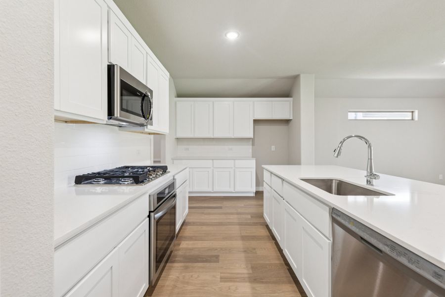 Kitchen in the Heisman home plan by Trophy Signature Homes – REPRESENTATIVE PHOTO Kitchen in the Heisman home plan by Trophy Signature Homes – REPRESENTATIVE PHOTO