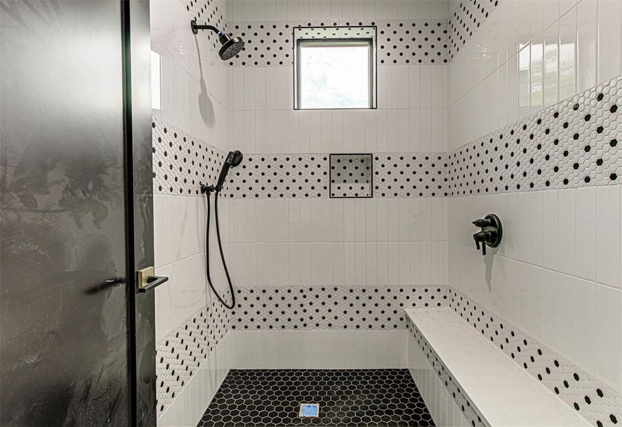 Upstairs Full bath featuring tile walls and tiled shower