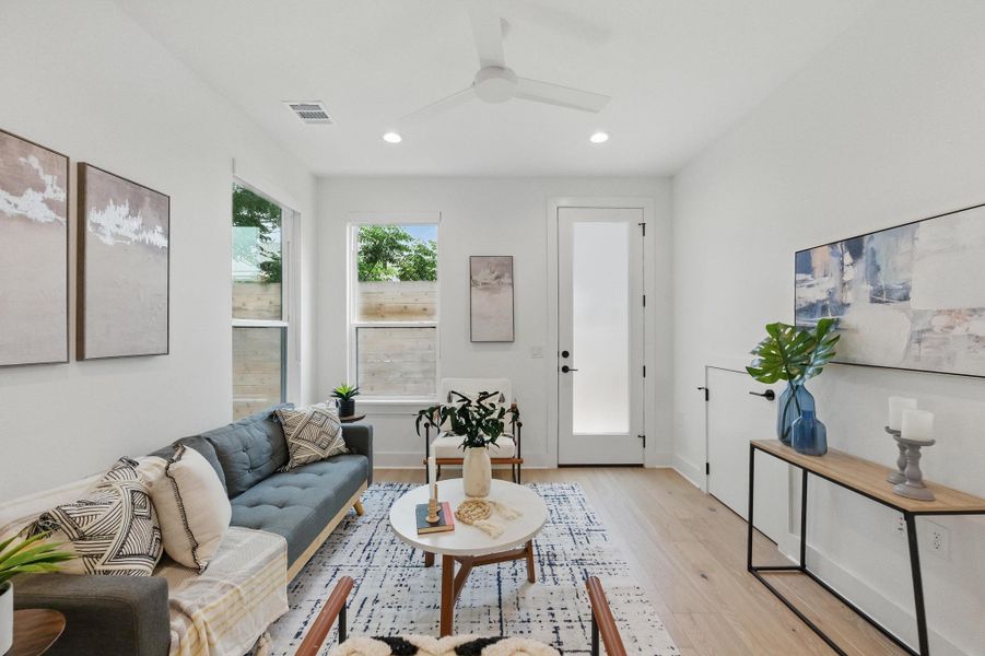 Living area featuring wood finished floors, recessed lighting, and a ceiling fan Living area featuring wood finished floors, recessed lighting, and a ceiling fan